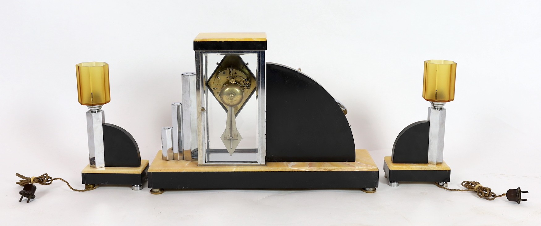 A French Art Deco chrome and marble clock garniture, by H. Loiseau of Chateauroux, clock 50cm wide, 35cm high, lamps 28cm high